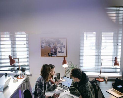 Team of colleagues discussing lifestyle content in a bright office